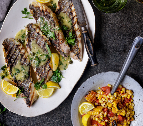 Grilled sea bass with charred tomato & corn salad