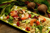 Grilled shrimp and scallions on barley with cucumbers, tomatoes, and feta