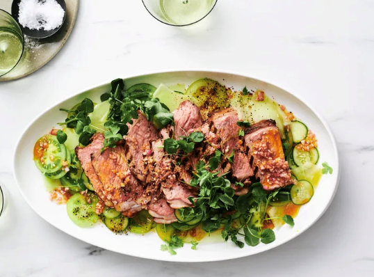 Grilled sirloin with harissa butter, green tomato and melon salad
