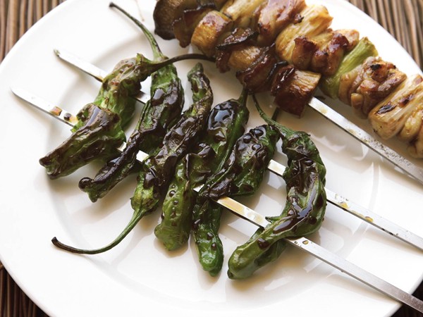Grilled skewered shishito peppers with teriyaki glaze 