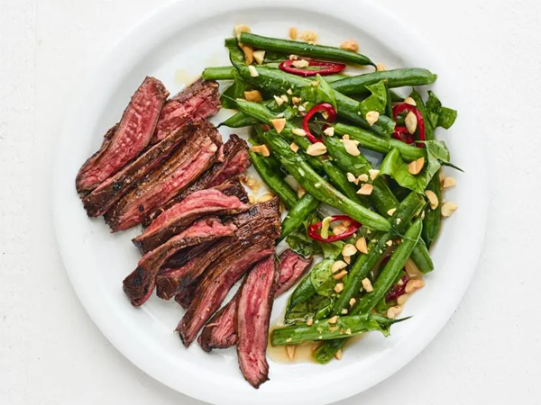 Grilled skirt steak with smashed green beans