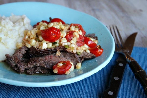 Grilled skirt steak with warm corn and cherry tomato salad