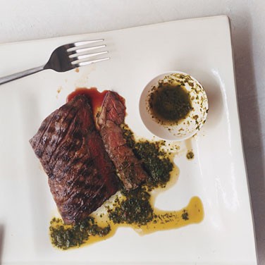 Grilled skirt steaks with parsley oregano sauce