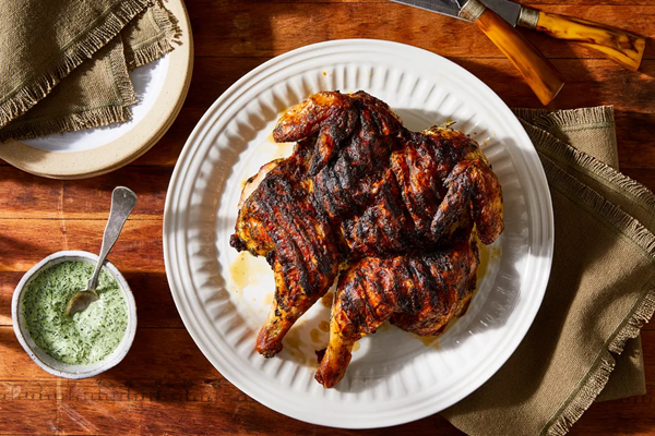Grilled spatchcock chicken with herby green sauce
