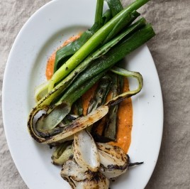 Grilled spring onions with romesco