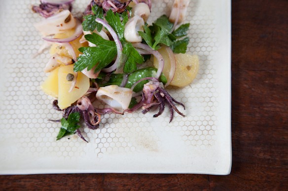 Grilled squid salad with lemon, capers, and parsley