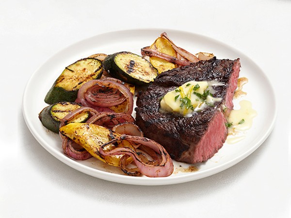 Grilled steak and vegetables with lemon-herb butter