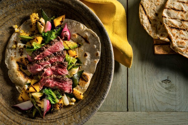 Grilled steak and vegetables with flour tortillas