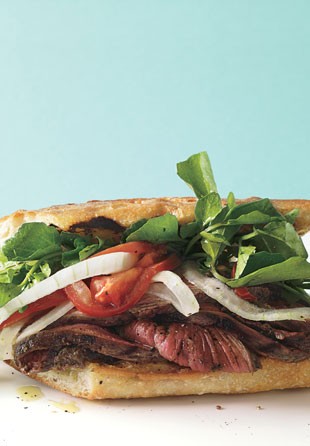Grilled steak sandwiches with marinated watercress, onion, and tomato salad