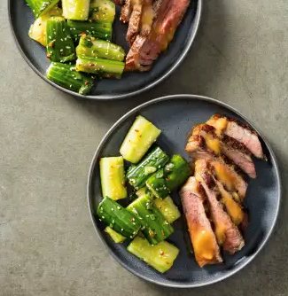 Grilled strip steaks with smashed cucumber salad