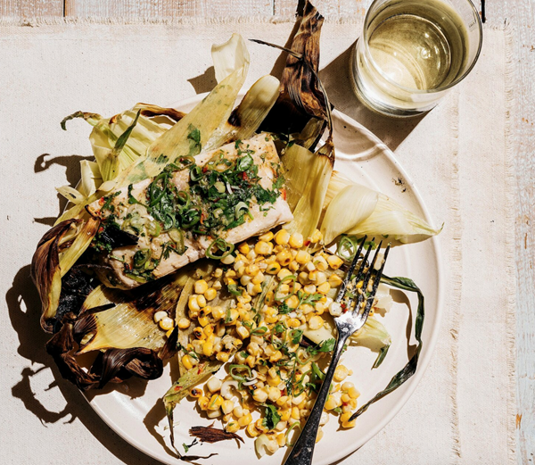 Grilled striped bass in corn husk pouches