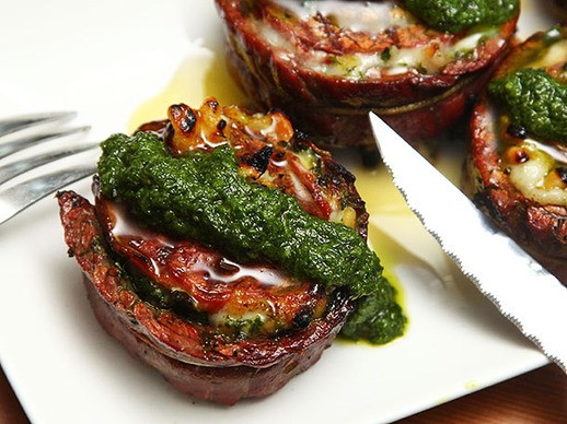 Grilled stuffed flank steak with pesto, mozzarella, and prosciutto