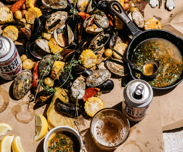 Grilled summer clambake with herbed garlic butter