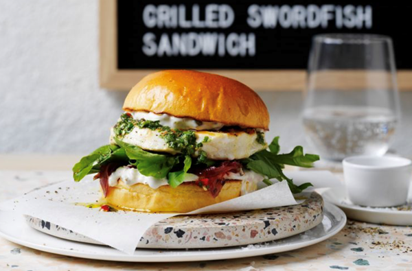 Grilled swordfish sandwich with caramelised onions and salsa verde