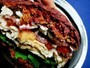 Grilled turkey, bacon, arugula, and blue cheese sandwiches on red beet buns