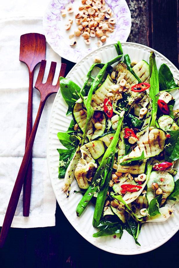 Grilled zucchini and green onions with baby spinach and hazelnuts