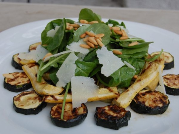 Grilled zucchini with arugula, Pecorino and pinenut salad