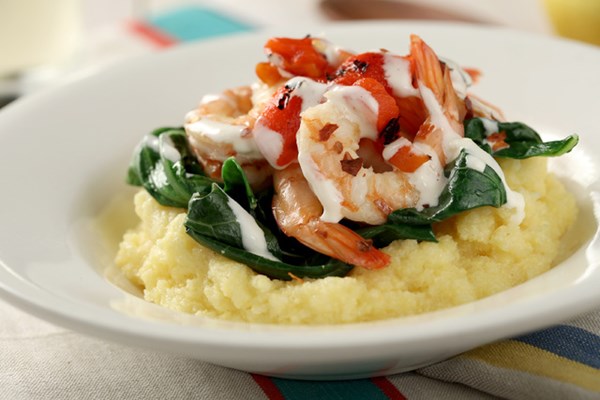 Grits with spicy collards, shrimp, roasted red peppers, and aioli drizzle