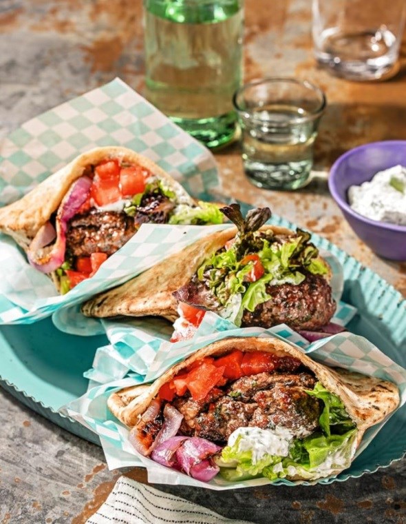 Gyro-style lamb burgers with tzatziki and grilled onions