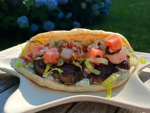Gyro-style lamb burgers with tzatziki and grilled onion