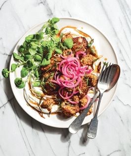 Harissa cauliflower with crispy green onions, labneh, and pickled red onion