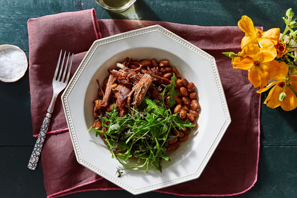 Harissa lamb, beans & garlicky greens