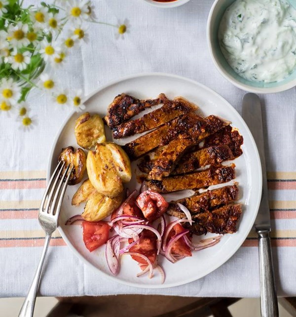 Harissa steak with tomato salad, tzatziki and crushed new potatoes