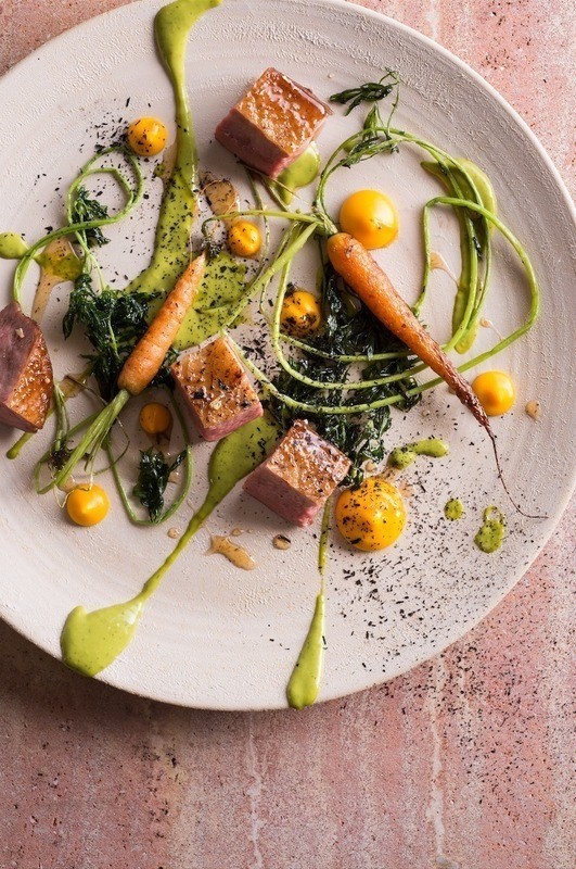 Hay-smoked duck breasts, carrot puree, and herb emulsion