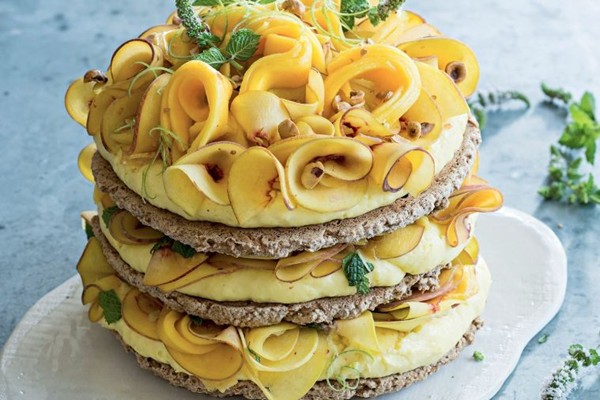 Hazelnut meringue cake with lime curd, peach & mango
