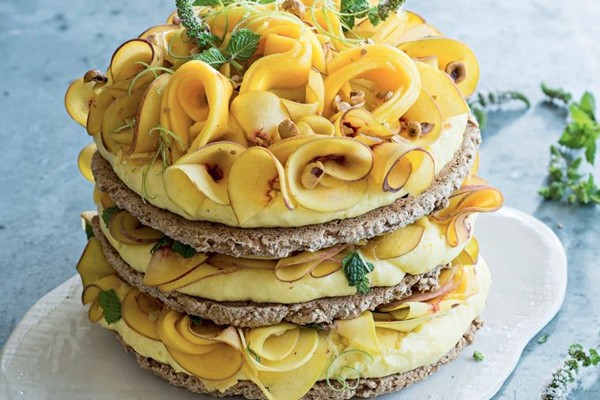 Hazelnut meringue cake with lime curd, peach & mango