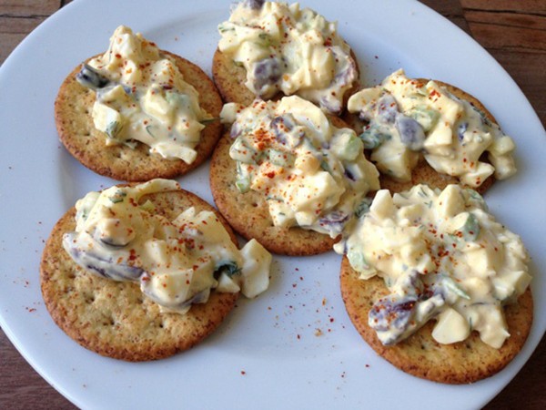 Healthy egg salad with yogurt, olives and scallions