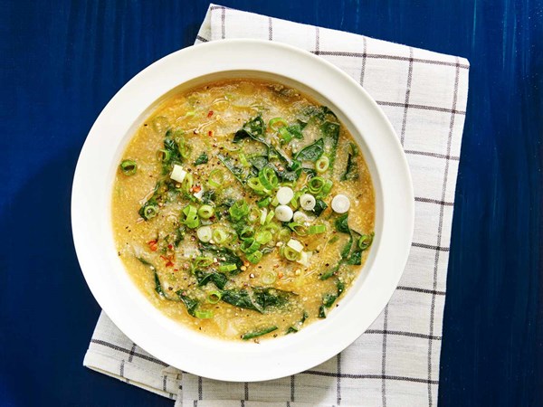 Hearty vegan polenta and kale soup with miso and toasted sesame oil
