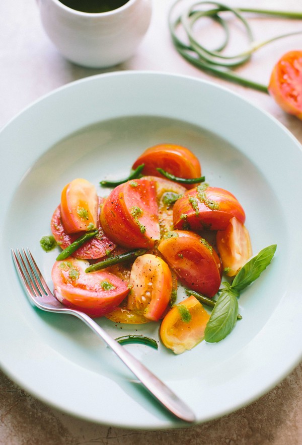 Heirloom tomatoes with garlic scape and basil vinaigrette