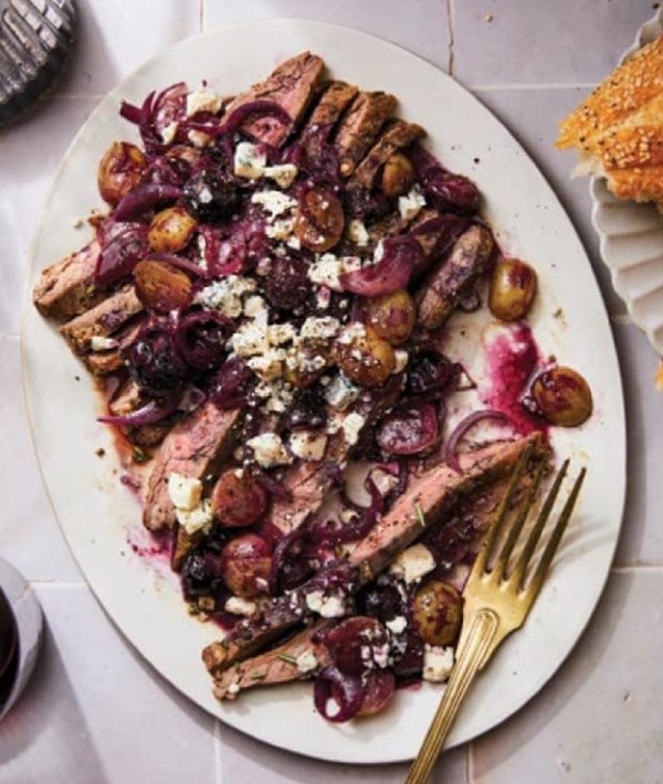 Herb-crusted flank steak with sauteed grapes and blue cheese
