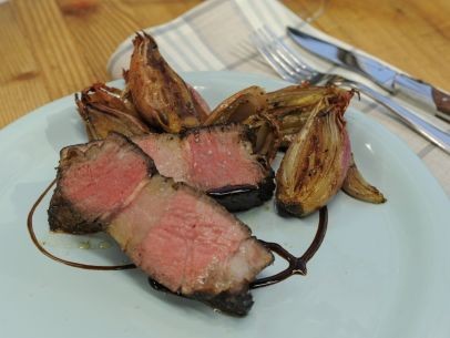 Herb-roasted beef rib-eye with roasted shallots