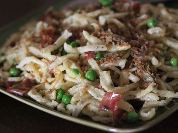 Herb spätzle with speck and peas