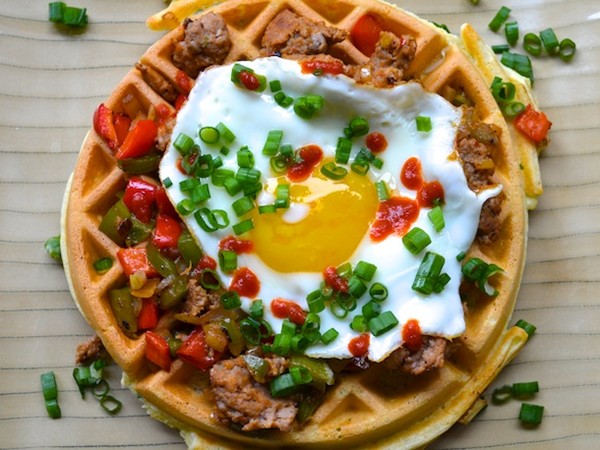 Herb waffles with sausage, peppers, and a fried egg