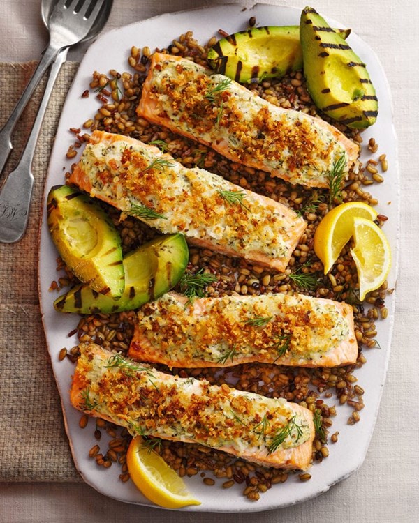 Herby crème fraîche salmon fillet with grilled avocado and mixed grains 