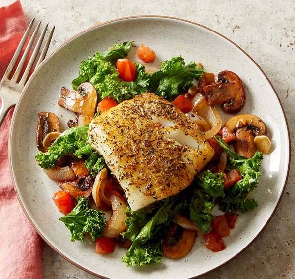 Herby fish with wilted greens & mushrooms