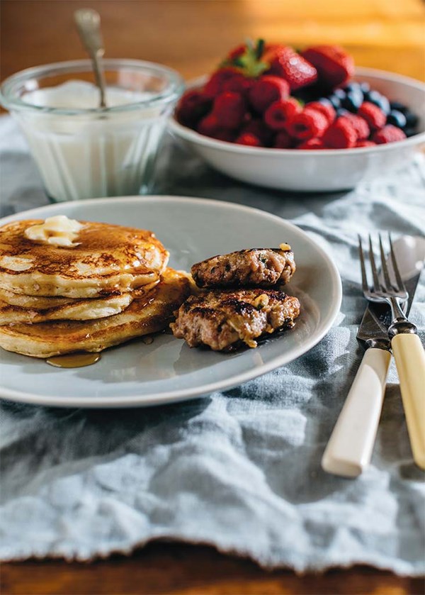 Homemade apple-maple sausage and buttermilk pancakes with cinnamon honey yogurt and seasonal fruit