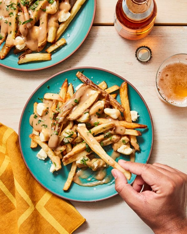 Homemade fries with gravy and cheese curds (Poutine)