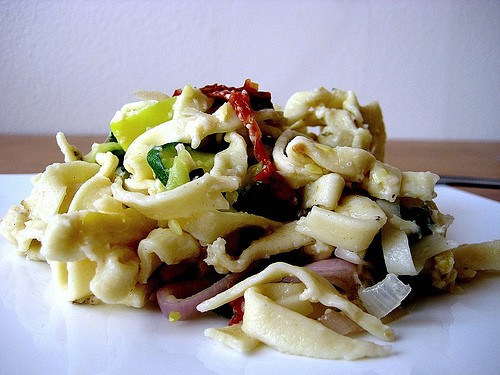 Homemade linguine with zucchini, capers, lemon, pine nuts, and herbs