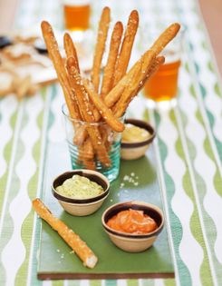Homemade pretzel sticks with three mustards