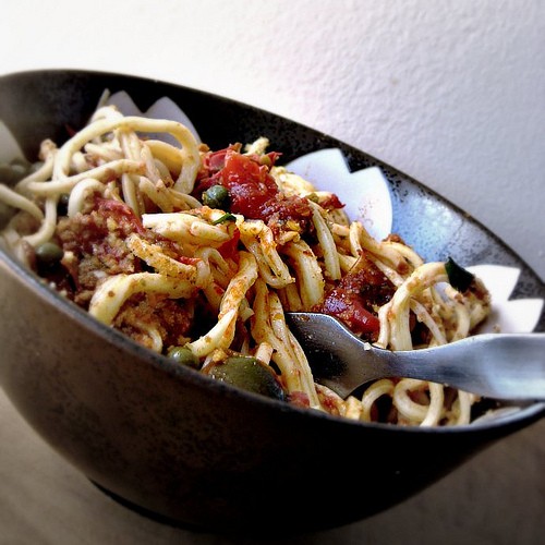 Homemade spaghetti with heirloom tomato, capers, anchovies, and chile