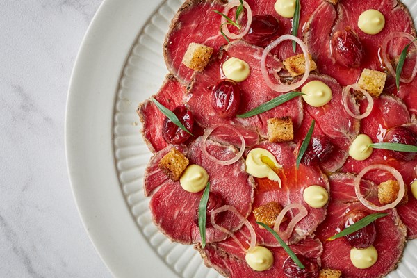 Horseradish beef carpaccio with mustard, tarragon and roast grapes