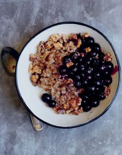 Hot farro porridge with blueberries and toasted walnuts