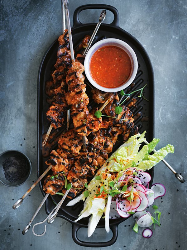 Hot pepper pork skewers with raw cabbage and radish kimchi