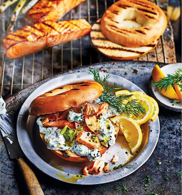 Hot smoked salmon bagels with grilled spring onion and herb soft cheese