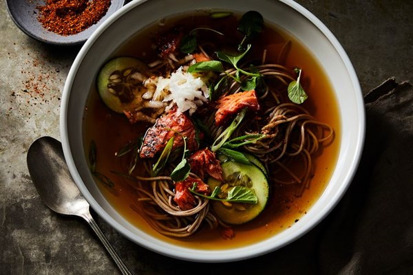 Hot soba noodle soup with salmon, cucumber, and togarashi