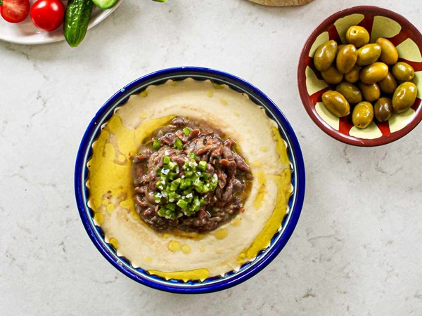 Hummus topped with fava beans (Qudsiyeh)